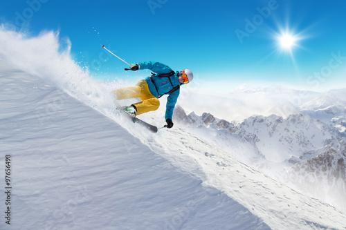 Man skier running downhill
