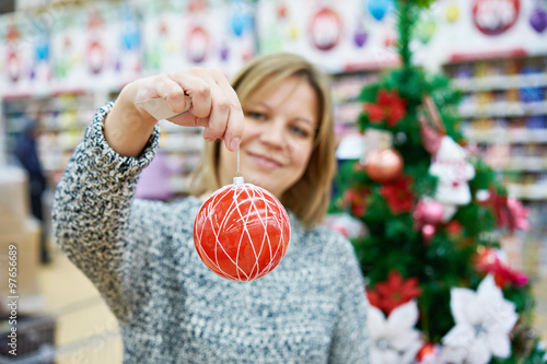 Beauty woman with red ball for the Christmas tree