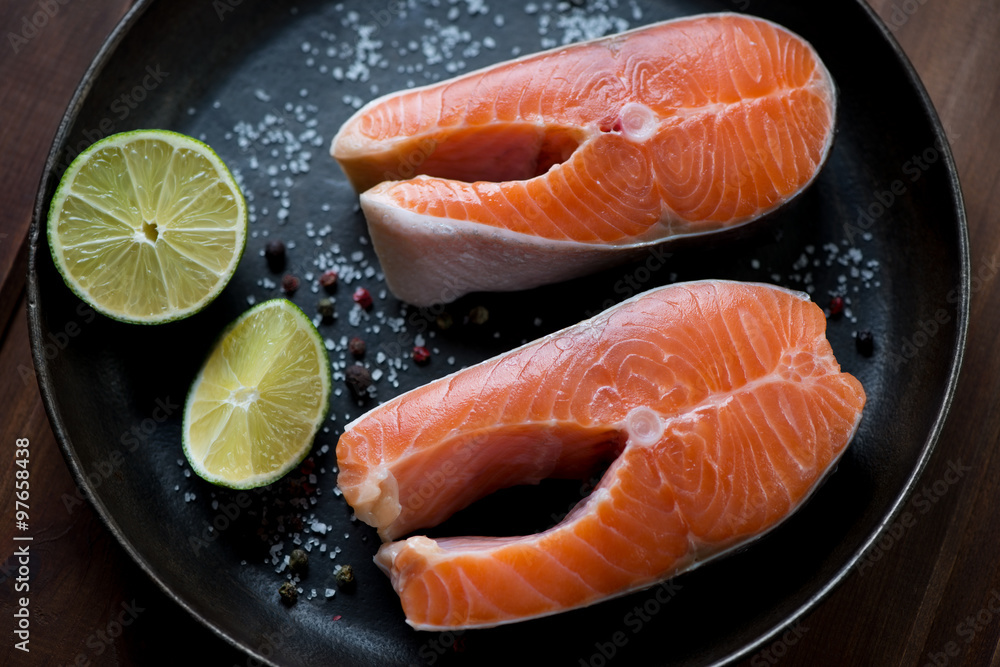 Two raw trout steaks in a frying pan ready to be cooked, closeup Two raw trout steaks in a frying pan ready to be cooked, closeup