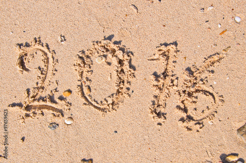 New Years 2016 concept; 2016 on the sand backgroung Texture