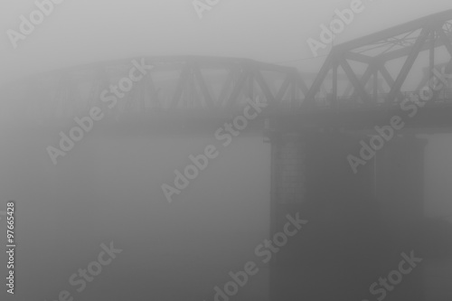 old iron bridge over wrapped in a mysterious fog