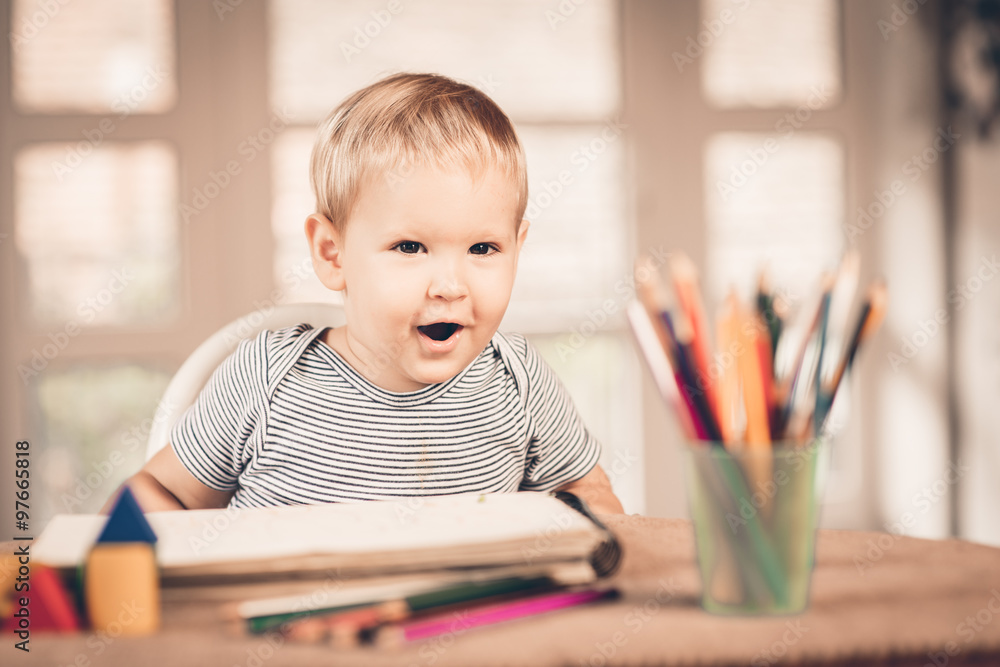 Blond smiling boy and crayons Blond smiling boy and crayons
