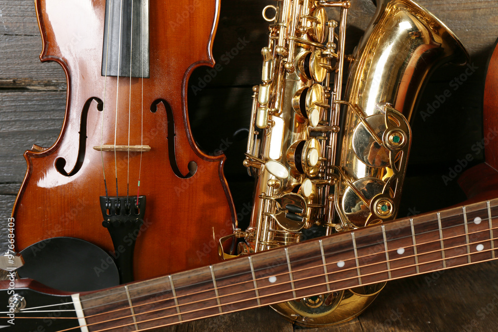Naklejka premium Close up view on musical instruments on wooden background
