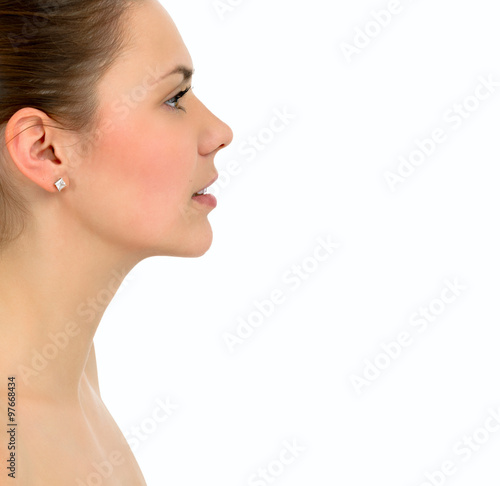 Portrait of a beautiful young woman in profile on a white background © pavelkriuchkov