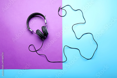 Black headphones on purple-blue background