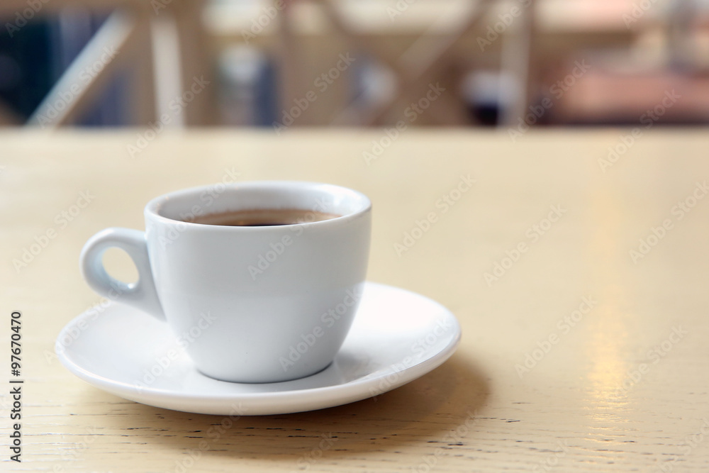 Cup of tasty coffee on cafe background