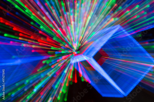 Festive and celebratory background. Disco lights. Laser show. Christmas lights in bokeh.