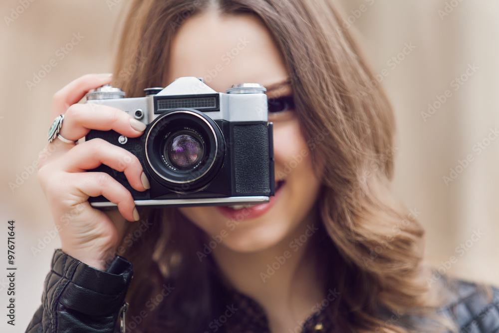 Portrait of a pretty young tourist taking photographs with vintage retro camera Portrait of a pretty young tourist taking photographs with vintage retro camera