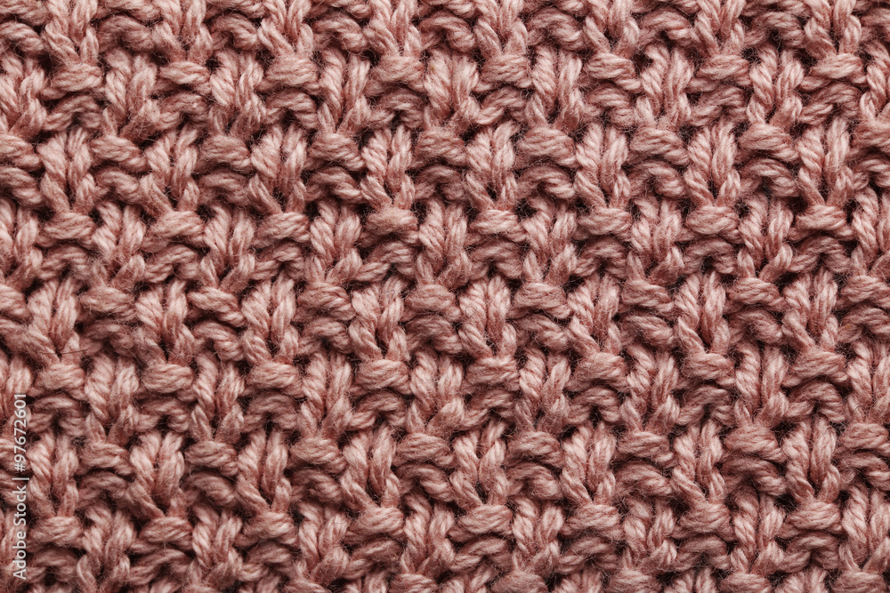 Knitted woolen fabric background, close up