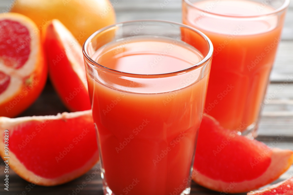 Glass of grapefruit juice and fresh fruits on wooden background Glass of grapefruit juice and fresh fruits on wooden background
