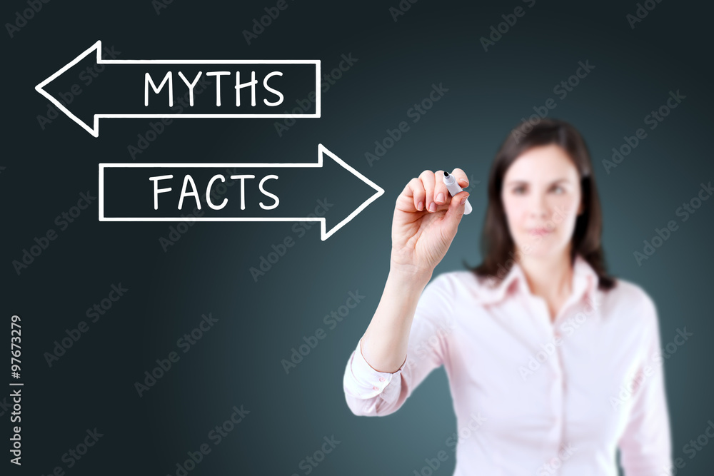 Businesswoman drawing a Myths or Facts concept on the virtual screen. Blue background. Businesswoman drawing a Myths or Facts concept on the virtual screen. Blue background.