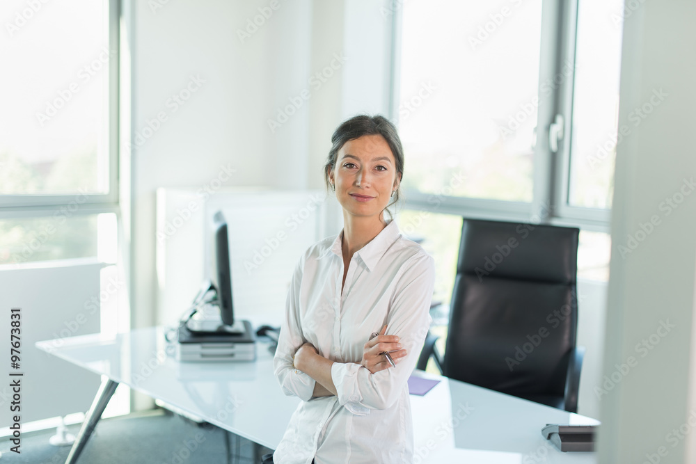 business woman leaning against her glass desk, luminous office
business woman leaning against her glass desk, luminous office