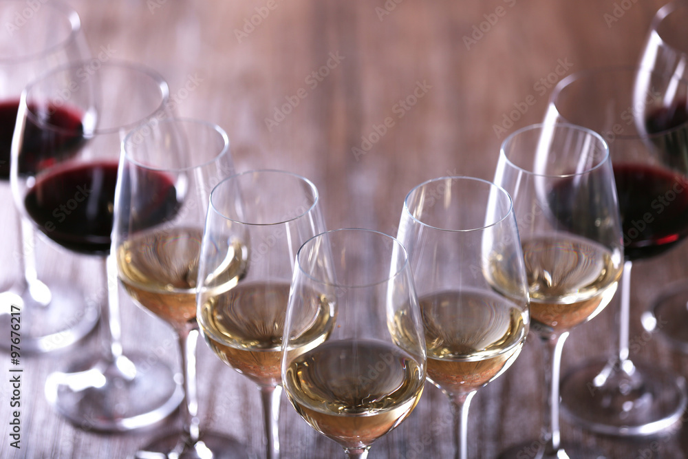 Wineglasses with white, red and pink wine on wooden table close-up Wineglasses with white, red and pink wine on wooden table close-up