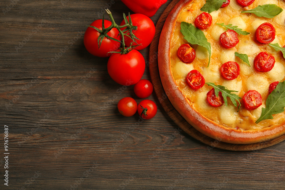 Pizza Margherita with arugula, tomatoes wooden table Pizza Margherita with arugula, tomatoes wooden table