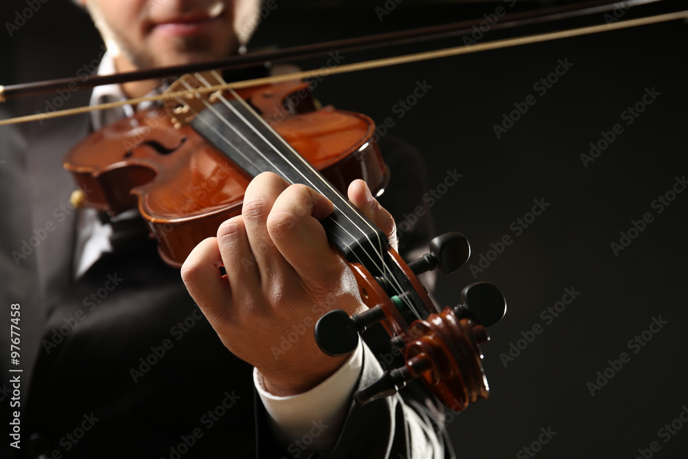 Musician play violin on black background, close up Musician play violin on black background, close up