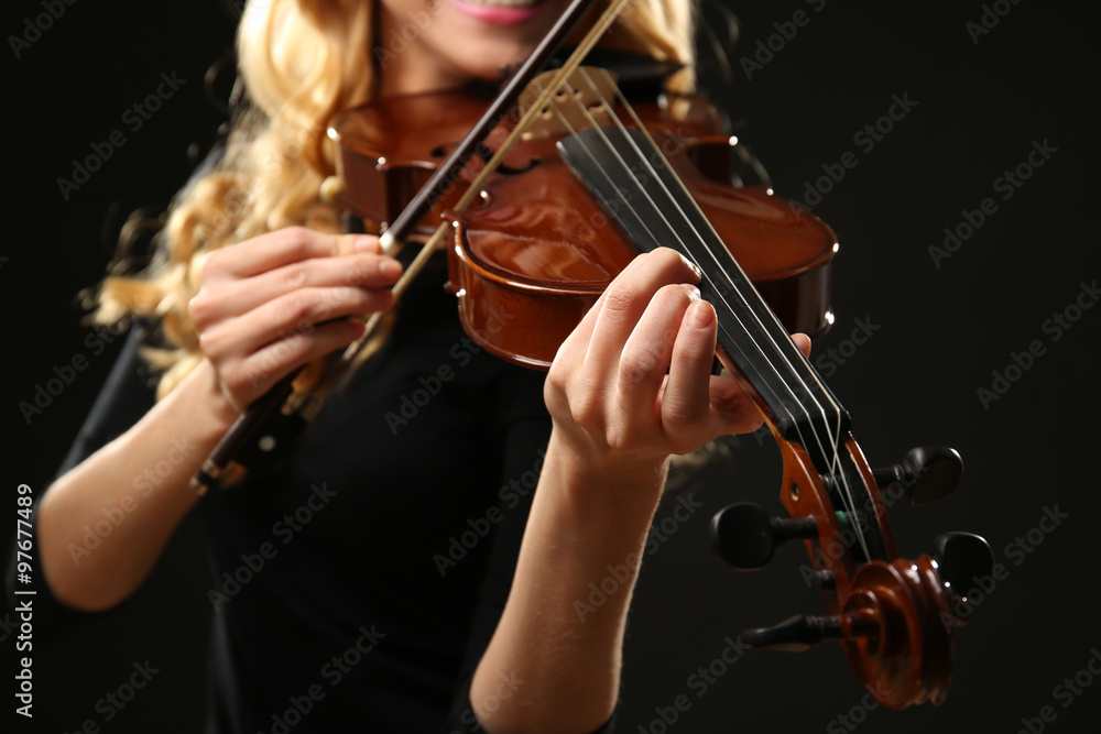 Musician plays violin on black background, close up Musician plays violin on black background, close up
