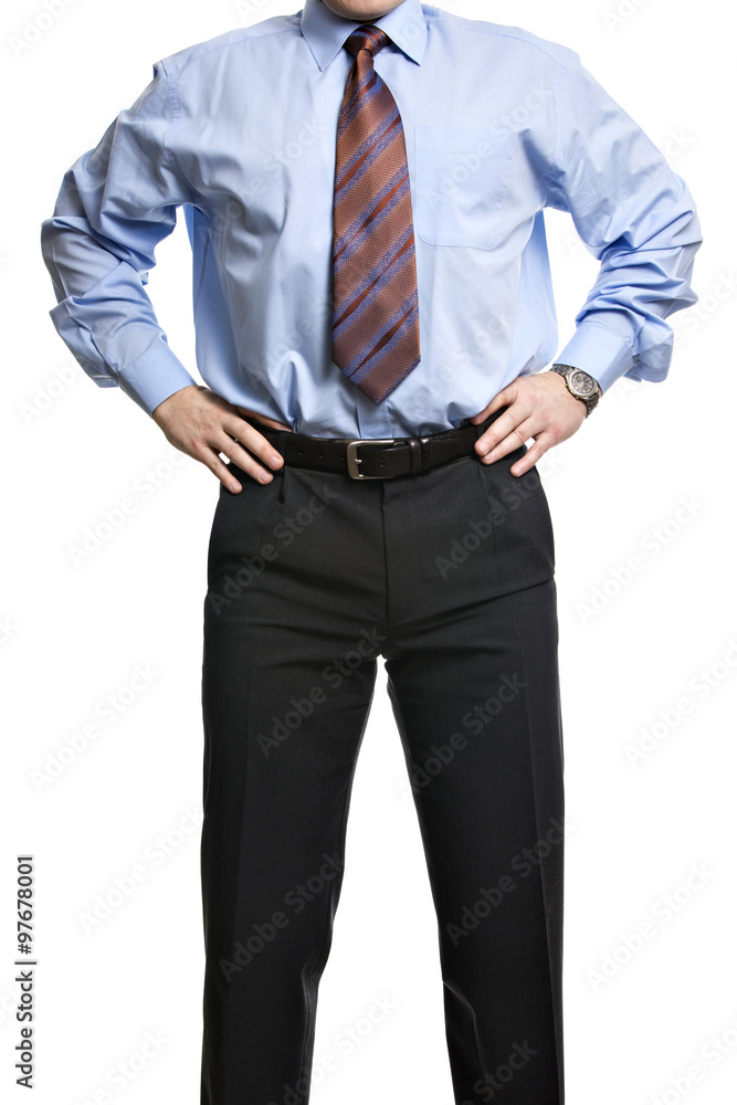 Businessman in blue shirt stands with hands on the waist Businessman in blue shirt stands with hands on the waist
