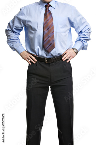 Businessman in blue shirt stands with hands on the waist