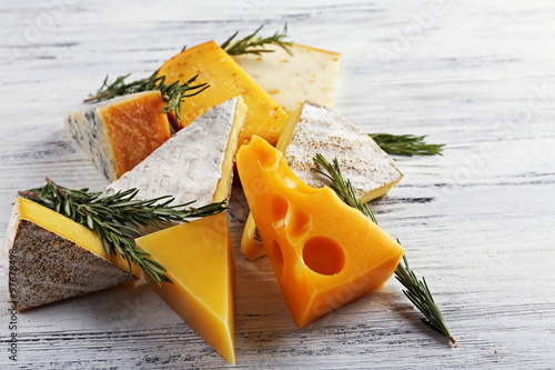 Different kinds of cheese on white wooden background, close up
