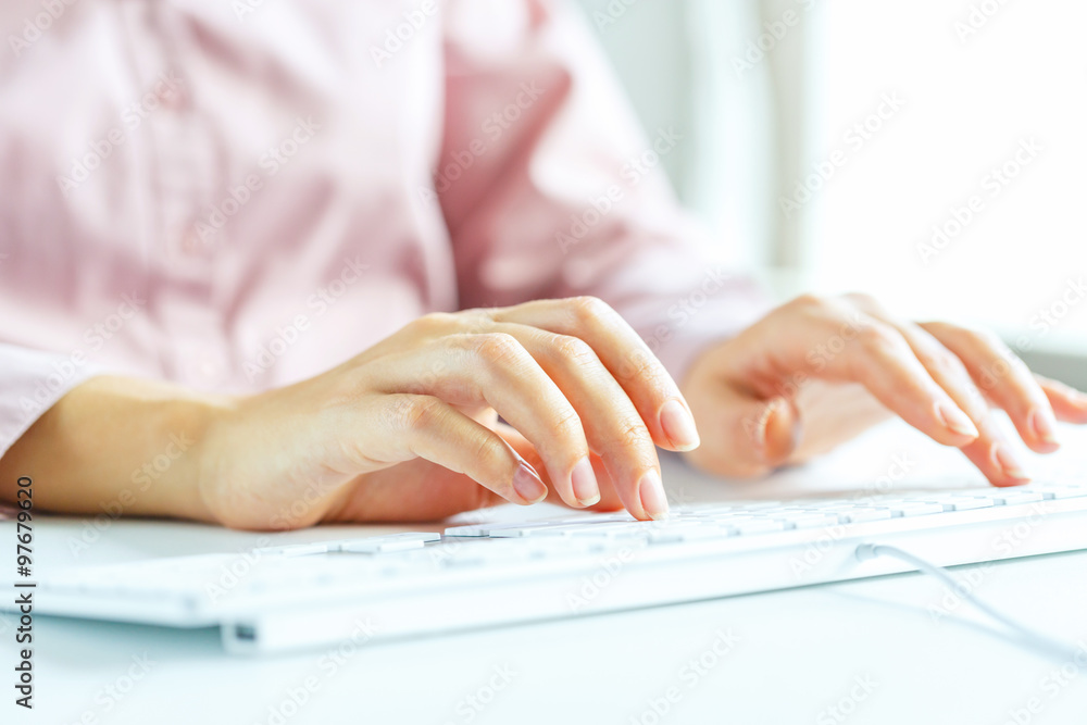 Woman office worker typing on the keyboard Woman office worker typing on the keyboard