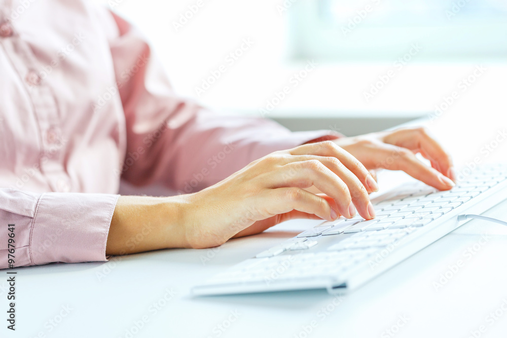 Woman office worker typing on the keyboard Woman office worker typing on the keyboard