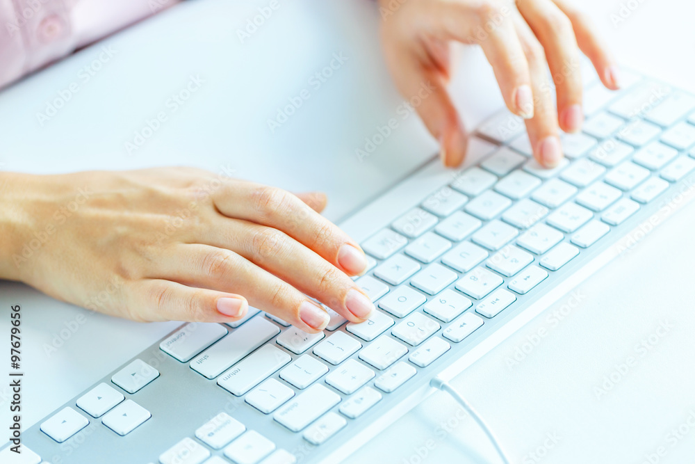 Woman office worker typing on the keyboard Woman office worker typing on the keyboard