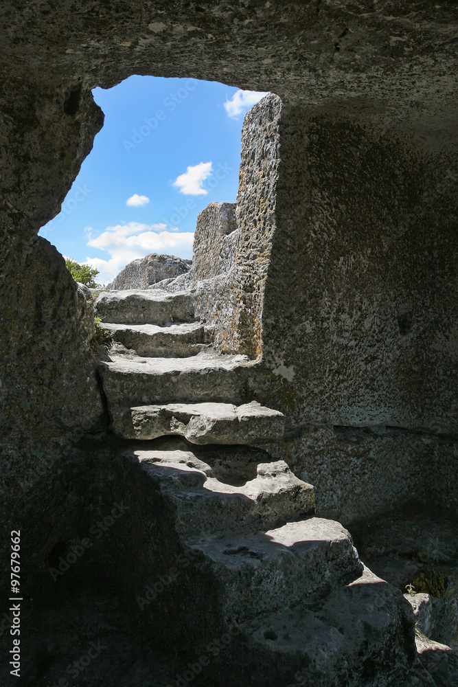 The stone steps leading to the cell in the rock. Through the doo