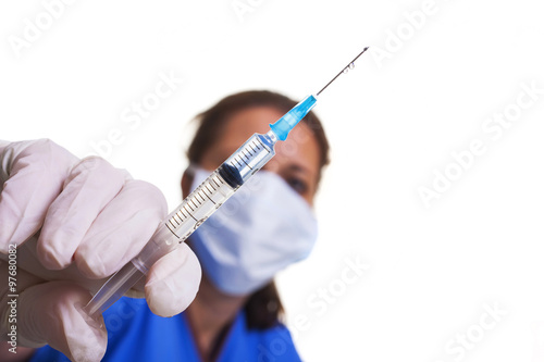 lab technician with mask and gloves holding a syringe with needle landscape