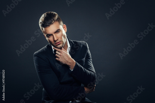 Portrait of handsome man in a studio on a dark background © djile