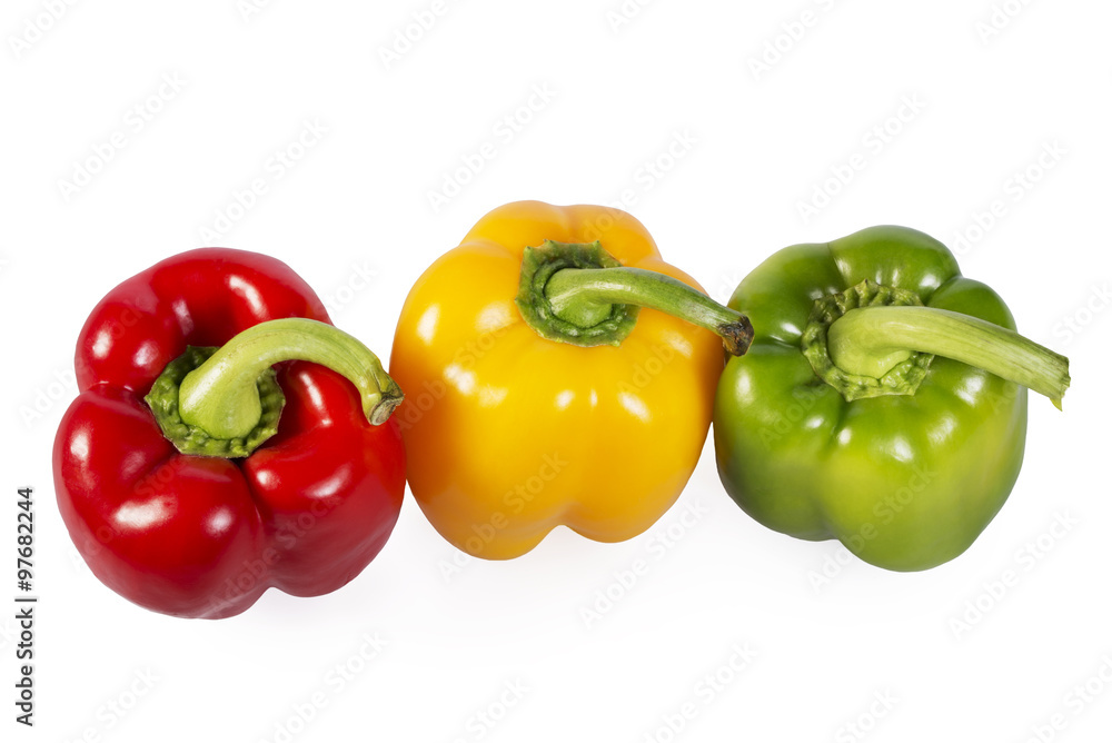 Red, green and yellow paprika on white