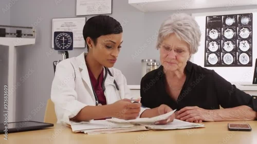 Young african doctor interacting with mature patient Young african doctor interacting with mature patient
