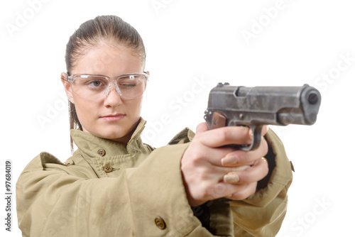  young woman with protective goggles holding a gun