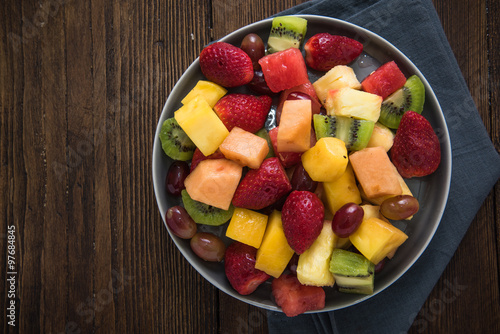 Plate full of healthy exotic fruits slices