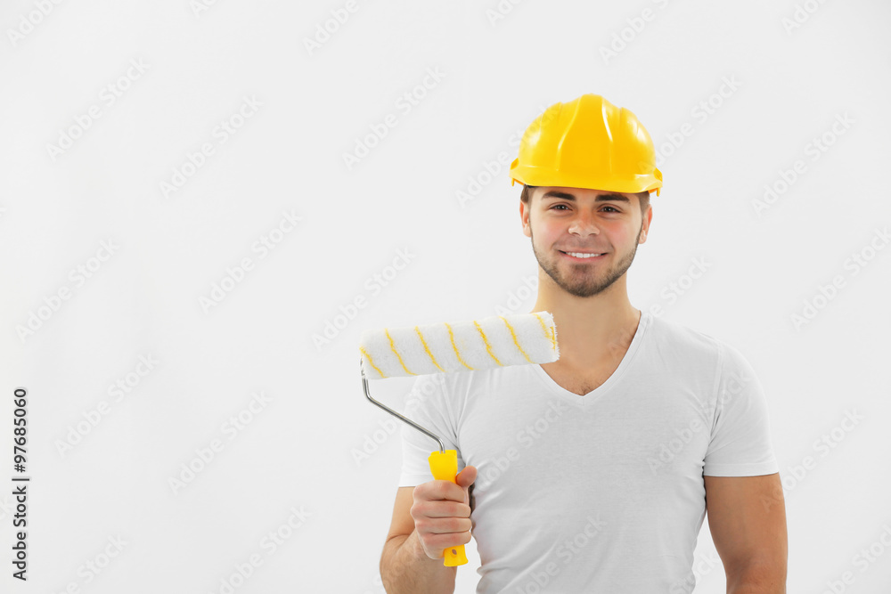 Worker renewing apartment on wall background Worker renewing apartment on wall background