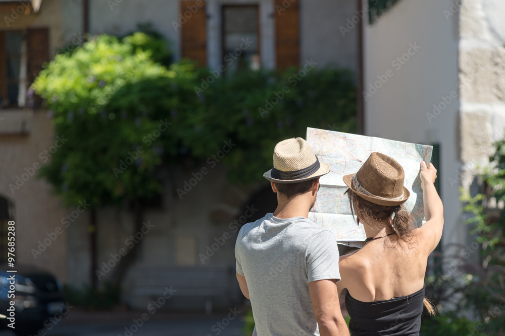  young couple on holiday looking at a map