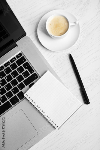 Empty notebook on laptop keyboard, on light background