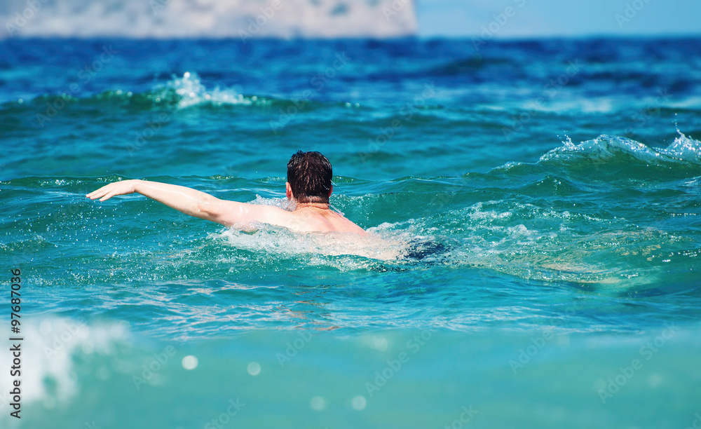 Man swimming in the sea. Vacation concept.