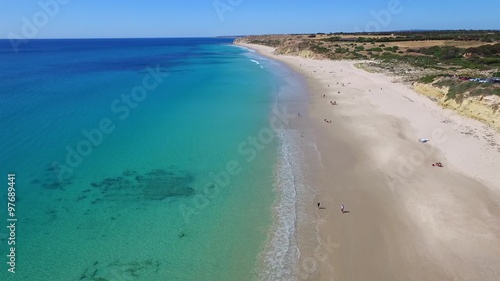 Aerial views of Adelaide Beaches Port Willunga with old shipping jetty & fishermen beach caves near Aldinga Beach in South Australia on Fleurieu Peninsula. Spectacular coastline cliffs and reef.  photo