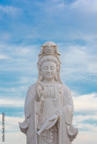 Guanyin Buddha statue on blue sky