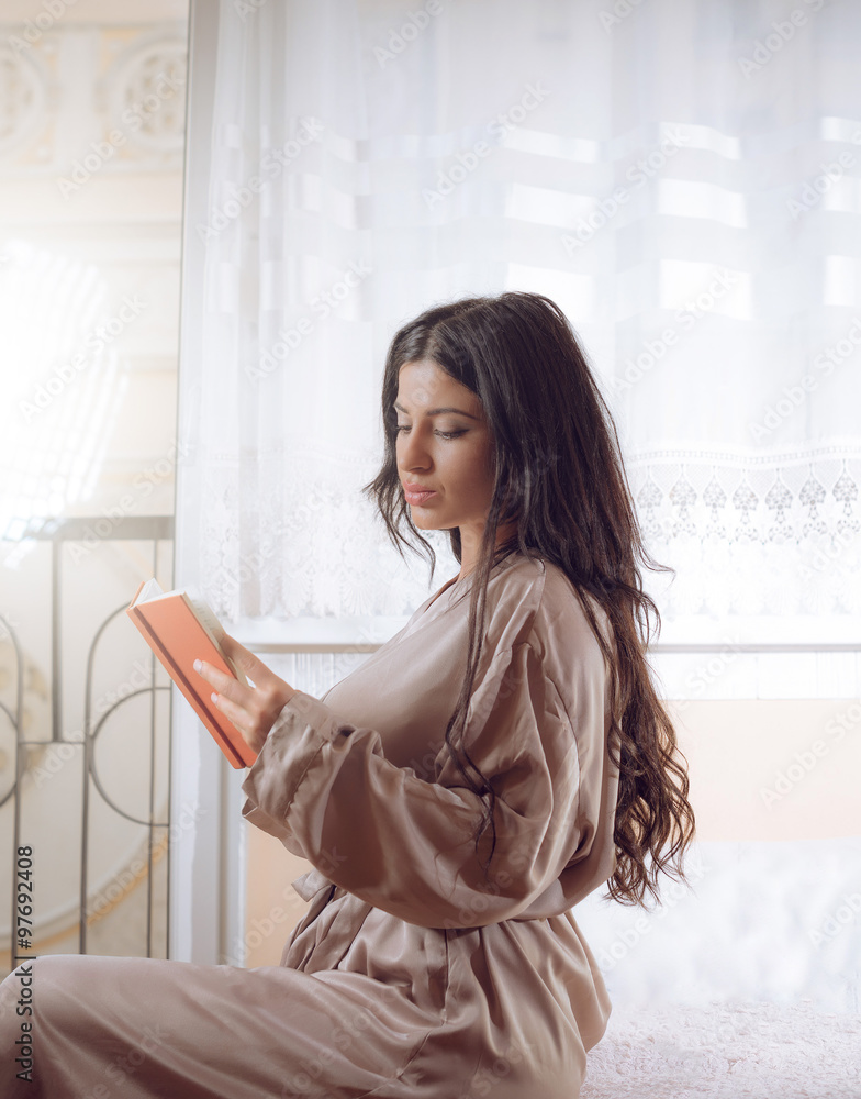 Elegant girl reading a book in apartment Elegant girl reading a book in apartment