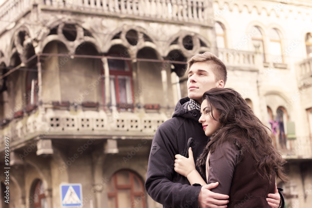 Young couple looking at same direction in sepia tone
