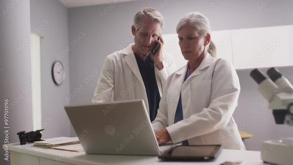 Two mature caucasian doctors working in a clinic Two mature caucasian doctors working in a clinic