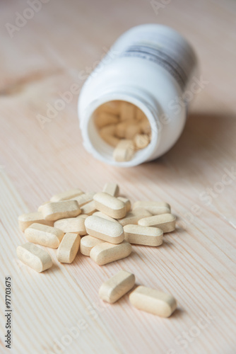 Vitamin capsules or medicines on wood table