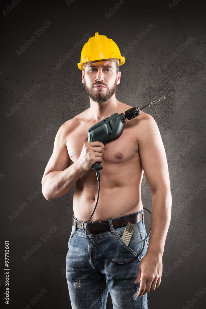 Portrait of attractive shirtless workman with drill Portrait of attractive shirtless workman with drill