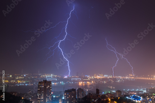 Lightning bolt over city.