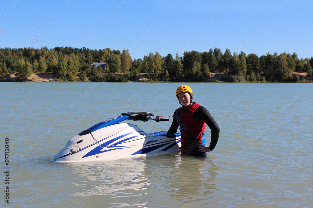 Naklejka premium Young man near his jet ski. 