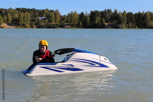 Young man near his jet ski.
 photo