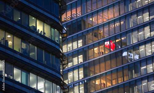 LONDON, UK - 7 SEPTEMBER, 2015: Canary Wharf office's windows lit up at dusk, Business life concept background