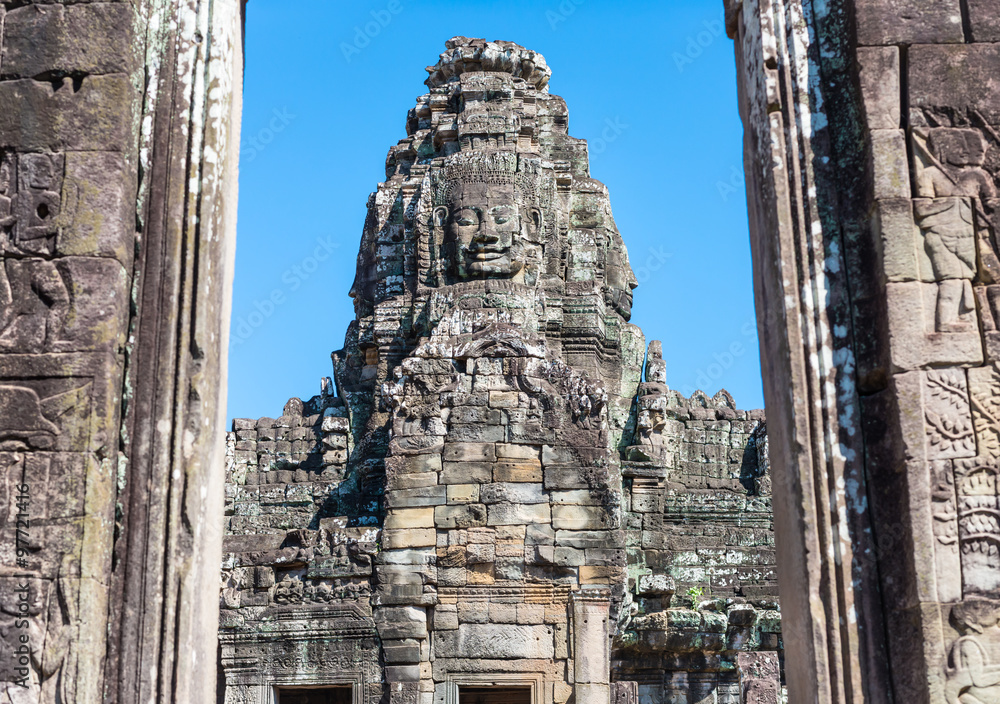 Ancient stone tower with smiling Buddha face in the doorway in Bayon temple, Angkor Wat, Cambodia