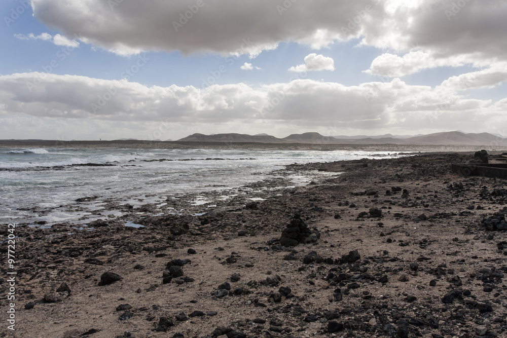 Dark landscape of rocks and ocean surf. Dark landscape of rocks and ocean surf.
